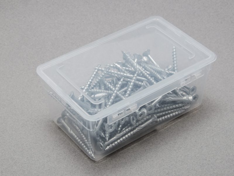 Top view of a closed plastic box filled with torx screws